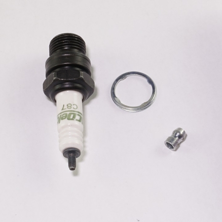 Spark plug, ring, and cap against white background, stamped "C87"