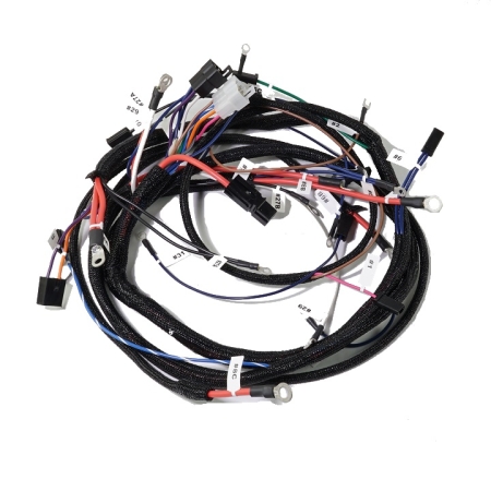 A nest of mostly red and blue wires, with black loom, coiled against a white background.