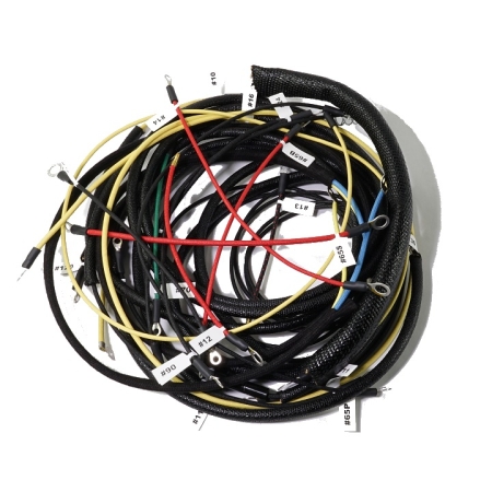 A nest of mostly red and yellow wires with black loom coiled against a white background.